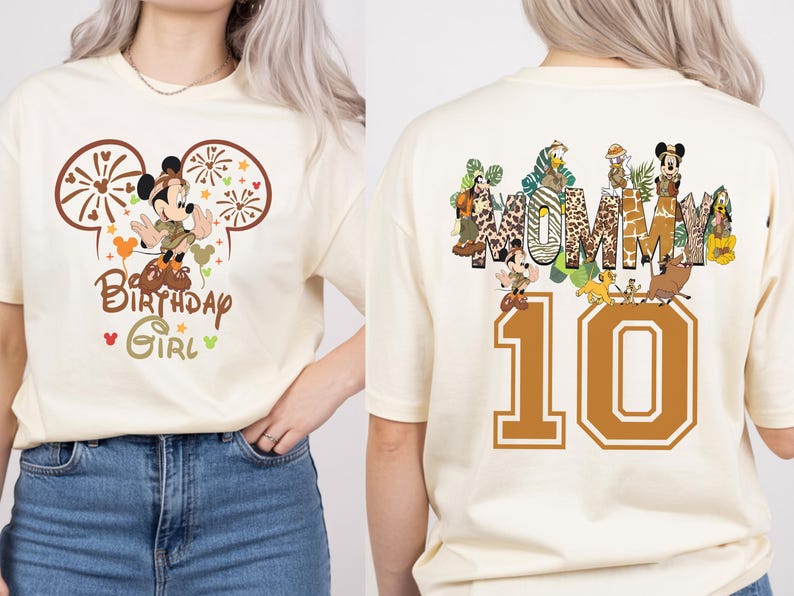 Puede incluir: Camiseta color crema con un dise&ntilde;o de Mickey Mouse, el texto "Birthday Girl" y el n&uacute;mero "10". La parte trasera de la camiseta tiene la palabra "MUMMY" y varios personajes de dibujos animados.
