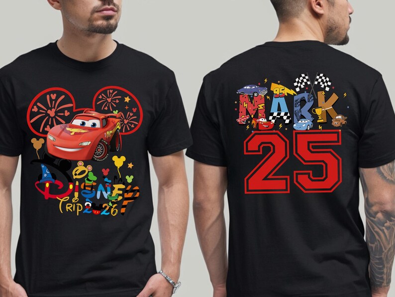 May include: Black t-shirt featuring a red Lightning McQueen car graphic with the text "Disney Trip 26" on the front. The back of the shirt displays the name "MARK" and the number "25" in red.