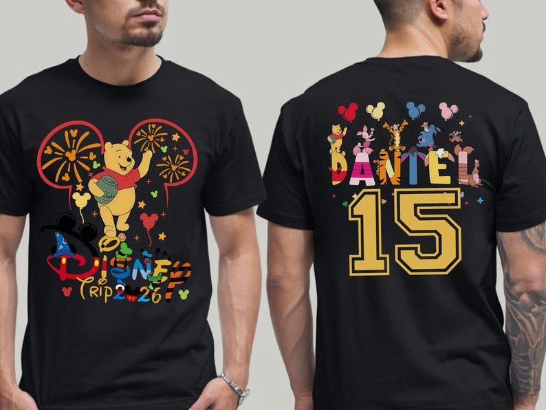 May include: Black t-shirt featuring a colorful Disney design with Winnie the Pooh, fireworks, and the text "Disney Trip 2-26" on the front. The back displays "DANIEL 15" with Disney characters.