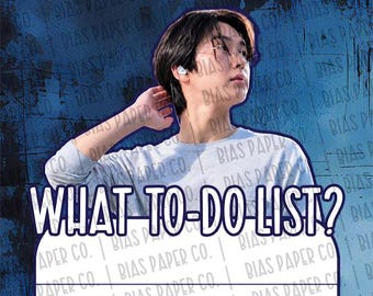 May include: A light grey long-sleeved shirt worn by a person with dark hair and glasses, featuring the text WHAT-TO-DO-LIST? in bold dark blue letters above a white lined paper section with the repeating watermark text BIAS PAPER CO.