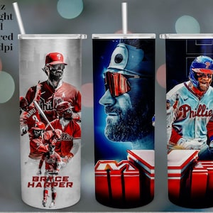 May include: A 20oz straight and tapered tumbler featuring baseball player Bryce Harper. The design includes images of Harper in his Phillies uniform, with the text "BRYCE HARPER" at the bottom. The tumbler has a straw.