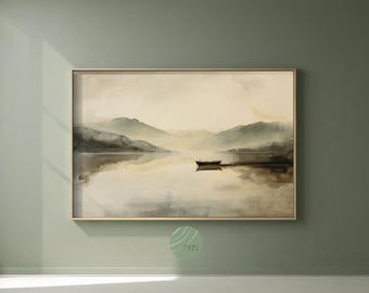May include: A framed landscape art print depicting a serene lake scene. The artwork features muted tones of beige, gray, and brown, with mountains in the background and a small boat on the water. The overall aesthetic is calm and atmospheric.