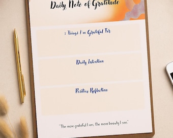 May include: A Daily Note of Gratitude notepad with sections for gratitude, daily intention, and positive reflection. The notepad has a brown border and includes the quote, "The more grateful I am, the more beauty I see."