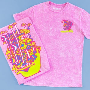 May include: Two pink tie-dye t-shirts with graphic designs. One shirt features a colorful, abstract face with mushrooms. The other shirt features a colorful, abstract face with the text "Killer Acid".