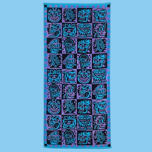 May include: A rectangular beach towel with a repeating pattern of black and turquoise cartoon faces on a purple and blue checkered background. The towel has a blue border and is displayed against a light blue backdrop.