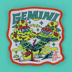 May include: A white patch with an orange border featuring a cartoon illustration of two mushroom-like creatures. The word "GEMINI" is at the top in green, with the text "Killer Acid" at the bottom. The design includes stars and lightning bolts.