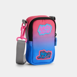 May include: A small blue and pink ombre crossbody bag with a zipper closure. The bag has a gray adjustable strap and features a pink and blue "Killer Acid" logo and a frog graphic.