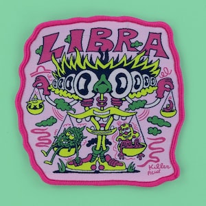 May include: Pink embroidered patch with the word "LIBRA" in pink and a cartoon illustration of a Libra zodiac sign. The patch features a whimsical design with multiple eyes, scales, and the text "Killer Acid".