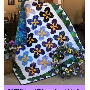 May include: A quilt pattern called "Pansy Party" featuring a white background with purple, blue, and yellow pansy-shaped blocks. The quilt is made with fabrics from Vineyard by Island Batik. The pattern is pre-cut friendly and can be made with 2 1/2 inch strips or 10 inch squares.