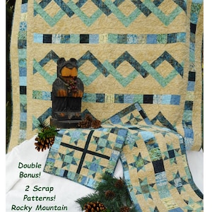 May include: A quilt pattern featuring a blue and green geometric design with a brown bear figurine in front. The pattern is called "Colorado Crossing" and is made with fabrics from "Winter Park" by Island Batiks. The pattern includes two scrap patterns: Rocky Mountain Sky Table Runner and Star Mini Quilt.