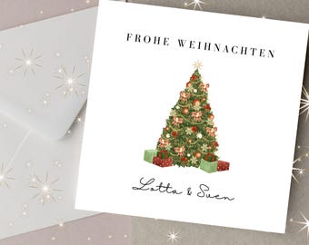 May include: A Christmas card with a decorated tree, gifts, and the text "FROHE WEIHNACHTEN" and "Lotta & Suen". The card is white with a matching envelope, and the background has a festive design.