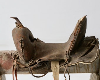 old leather saddle, rustic country western decor