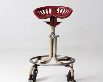 vintage industrial rolling stool with cast iron tractor seat