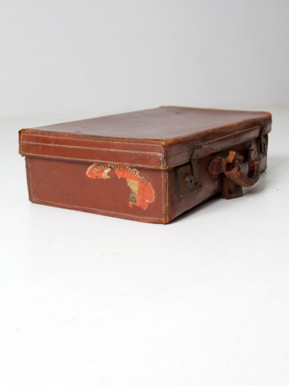 antique leather suitcase with travel stickers - image 1
