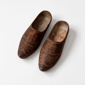 antique carved wooden clogs, decorative wood shoes