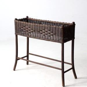 antique woven wicker planter stand