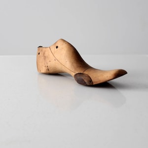 antique cobbler&#39;s last, wood shoe form with leather patches, wooden foot last