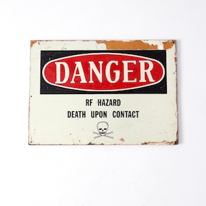 vintage metal Danger sign mounted on wood