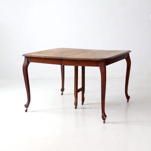 antique Queen Anne style dining table with leaves