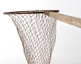 antique fish net on pole, large hand held fishing net