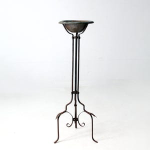 antique wrought iron plant stand with copper bowl