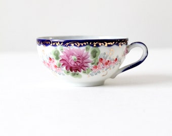 antique tea cup with gilt, floral porcelain cup