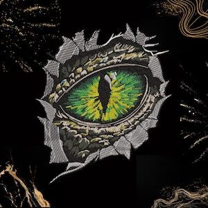 May include: Embroidered patch featuring a detailed dragon eye with green and yellow iris, set against a black background. The eye is framed by a textured, gray and green design, giving a 3D effect. The patch is suitable for clothing or accessories.