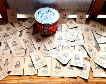 May include: An assortment of vintage trading cards featuring portraits of historical figures, scattered around a red and white Lion Coffee tin. The tin has a label that says "5¢ off". The cards are tan with black and white illustrations.