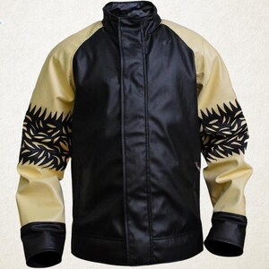 May include: A black and tan jacket with a stand-up collar. The jacket has black sleeves with a decorative black pattern on the upper arm. The front of the jacket is black, and the sleeves are tan. The brand name "Luxury Jackets" is in the upper left corner.