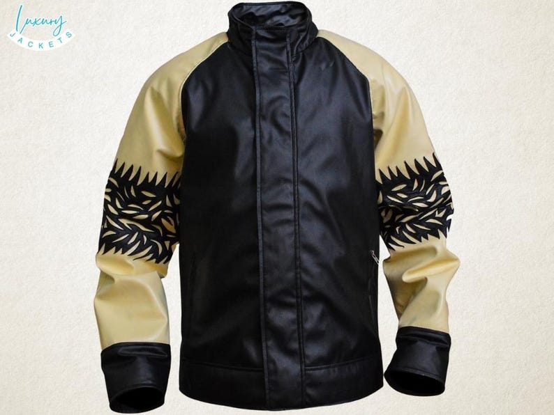 May include: A black and tan jacket with a stand-up collar. The jacket has black sleeves with a decorative black pattern on the upper arm. The front of the jacket is black, and the sleeves are tan. The brand name "Luxury Jackets" is in the upper left corner.