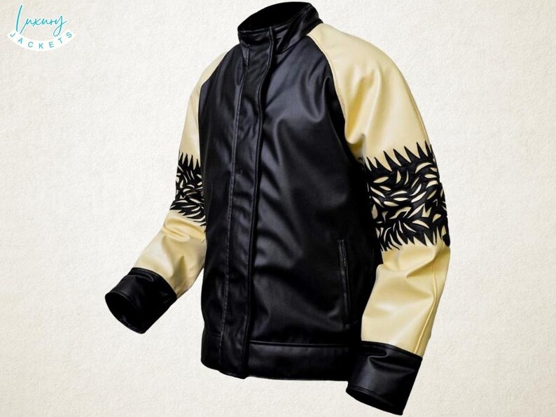 May include: Black and cream-colored leather jacket with a stand-up collar. The jacket features black sleeves with cream-colored shoulder panels and decorative black leaf-like cutouts. The jacket has a front zipper and a small pocket.