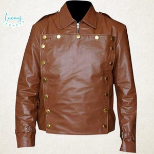 May include: A brown leather jacket with a black collar and gold-colored buttons. The jacket has a zipper closure and buckle details on the sleeves. The text "Luxury Jackets" is visible in the upper left corner.