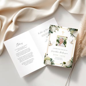 May include: A memorial card with a photo of a woman, surrounded by white flowers and doves. The card reads "Celebrating the Life of Cornelia Anderson" with dates. The open card displays an obituary and order of service.