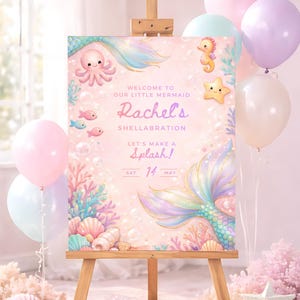 May include: A mermaid-themed party sign on an easel, featuring pastel colors and aquatic illustrations. The sign reads "Welcome to Our Little Mermaid Rachel's Shellabration. Let's Make a Splash!" with the date May 14th. Balloons in pink, white, and purple surround the sign.