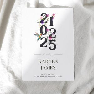 May include: A white wedding invitation card featuring the date 21 02 25 in large black numerals, decorated with floral and hummingbird illustrations. The text "The Wedding of KARYEN & JAMES" is below the date, with the date and address at the bottom.