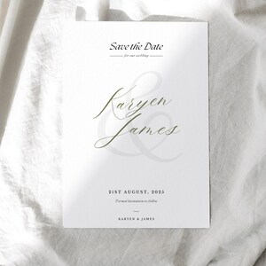 May include: A white wedding invitation card with the text "Save the Date" at the top. The names "Karyen & James" are written in elegant script. The date "21st August, 2025" is included, along with the phrase "Formal invitation to follow."