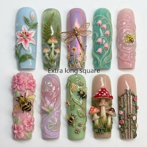 May include: Ten extra long square press-on nails featuring 3D relief designs including lilies, ferns, mushrooms, dragonflies, lily of the valley, bees, lotus flowers, and a garden gate. The set displays various colors like blue, green, pink, and iridescent tones.