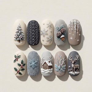 May include: A set of ten press-on nails featuring winter-themed 3D designs including a pine tree, cable knit texture, snowflakes, pinecones, icicles, holly berries, a snowy cabin, bare branches, and a deer on a neutral, gray, and white palette.