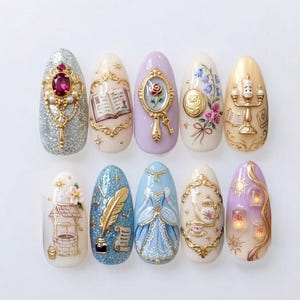 May include: A set of ten almond-shaped press-on nails featuring intricate 3D embellishments and detailed hand-painted designs. Themes include a silver glitter base with a red gem, an open book, a hand mirror, floral motifs, a candelabra, a wishing well, a quill, a blue gown, a teapot, and floating lanterns.