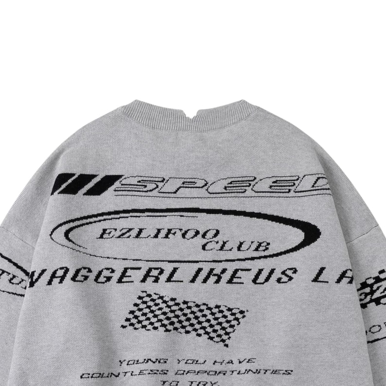 May include: A gray sweater with black text and graphics. The word "SPEED" is above an oval that says "EZLIFOO CLUB". Below is "VAGGERLIKEUS LA" and a checkered flag graphic. The bottom text reads "YOUNG YOU HAVE COUNTLESS OPPORTUNITIES TO TRY."
