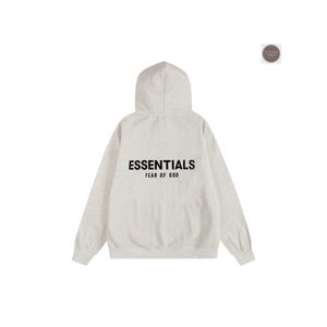 May include: A light gray hoodie with the word "ESSENTIALS" printed in black across the back, with "FEAR OF GOD" below it. The hoodie has a hood and long sleeves. The background is white.
