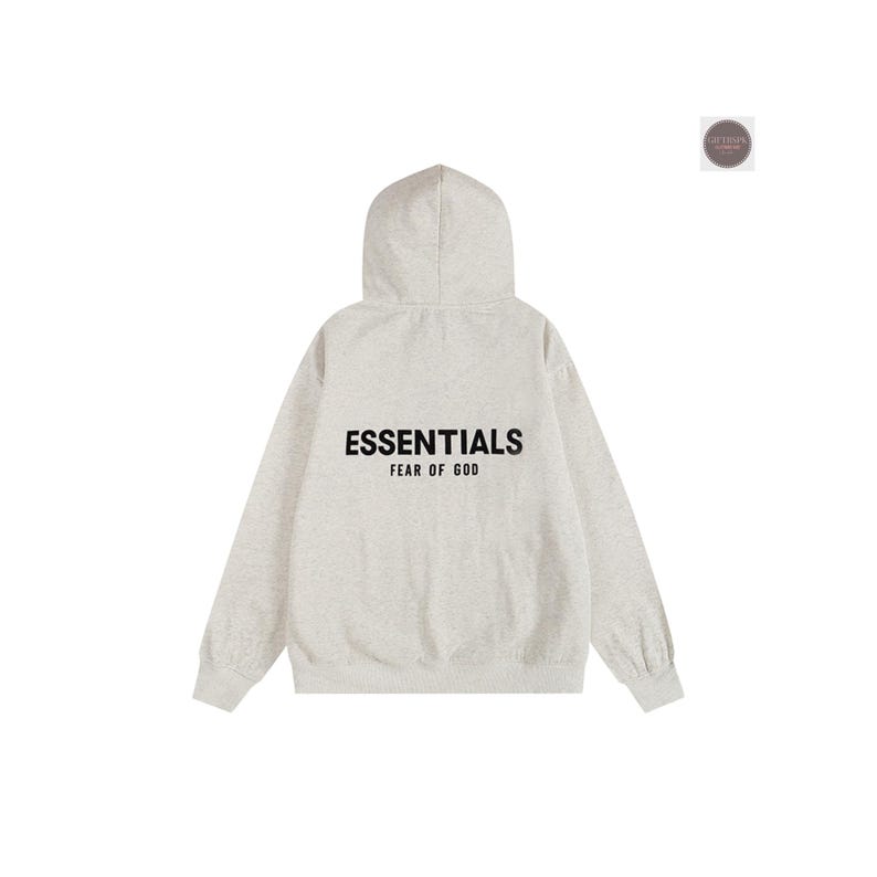 May include: A light gray hoodie with the word "ESSENTIALS" printed in black across the back, with "FEAR OF GOD" below it. The hoodie has a hood and long sleeves. The background is white.