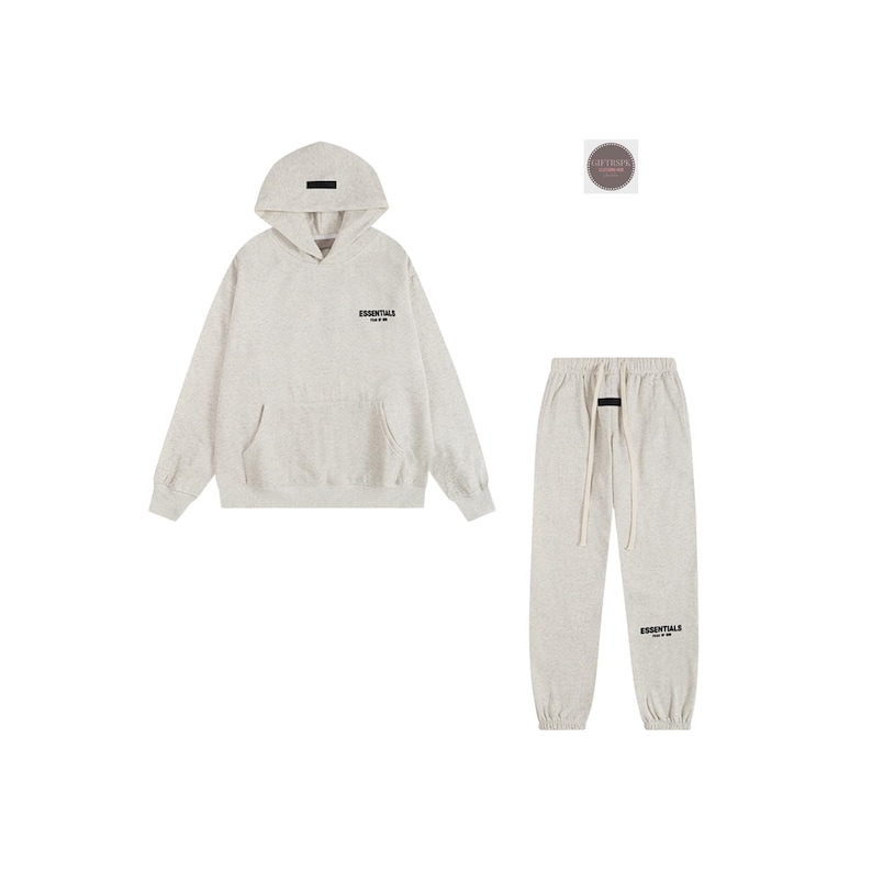May include: A light gray hoodie and matching sweatpants set. The hoodie has a front pocket and a small logo on the chest. The sweatpants have a drawstring waist and a logo on the lower leg. The set is made of a soft, comfortable material.