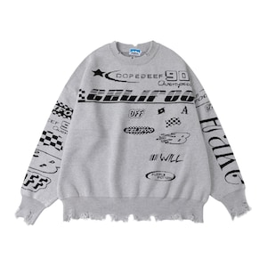 May include: A gray sweatshirt with distressed edges and black graphic text. The text includes "DOPEBEEF 90", "CALIFOO", "OFF", "WILL", and other racing-themed designs. The sleeves also feature text and checkered patterns.