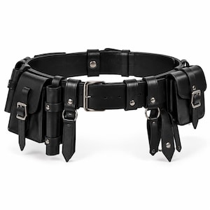 May include: A black utility belt featuring multiple attached pouches and cylindrical holders. The belt is constructed with silver-toned metal buckles, rivets, and D-rings. Each pouch is secured with a flap and a buckle closure system.