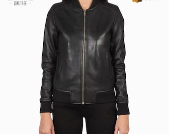 May include: A black leather bomber jacket with a zipper closure, ribbed cuffs, and a ribbed hem. The jacket is worn by a person. The image includes the text "LEATHER QUALITREE" and "LEATHER GALAXY CO."