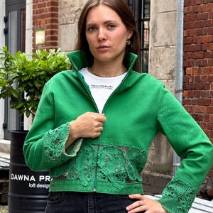 Unique emerald green denim jacket adorned with handcrafted Irish lace. An elegant designer piece.