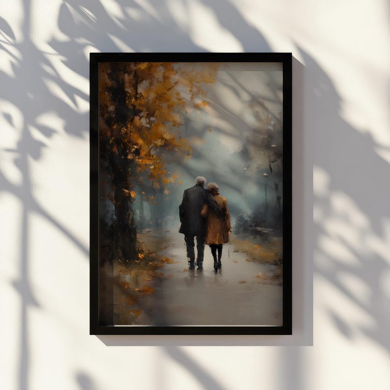 May include: Framed art print depicting an elderly couple walking arm-in-arm on a path. The artwork features a muted color palette with shades of brown, gold, and gray, evoking a sense of nostalgia and tranquility. The scene is set in a park during autumn.