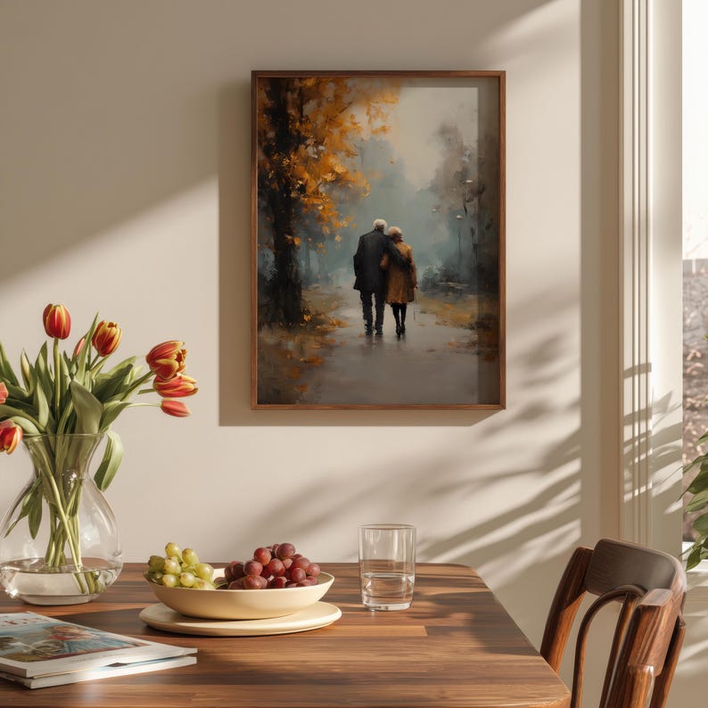 May include: A framed art print depicts an elderly couple walking on a path in a park. The artwork features a muted color palette with shades of brown, yellow, and gray. The scene is set in a park with trees and a pathway, evoking a sense of peace.