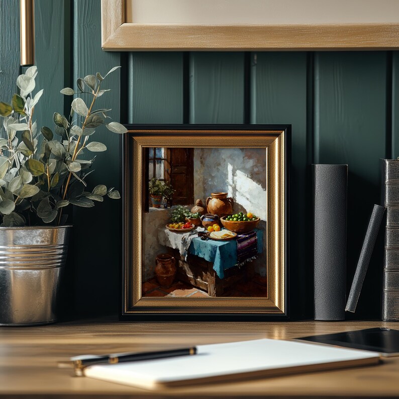 May include: A framed painting depicting a still life scene with a table set with food and pottery. The painting has a gold frame and is set against a dark green wall. A plant in a metal pot is on the left.